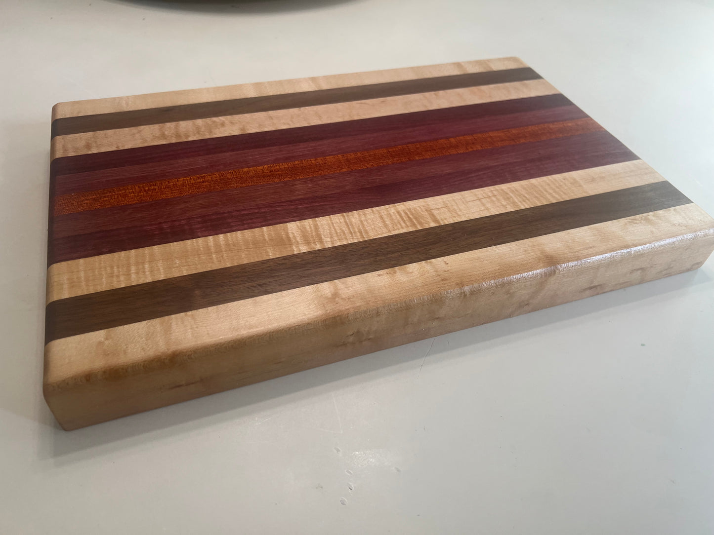 Hand made Hardwood Cutting board - Made from walnut, maple, Purple Heart, and blood wood.