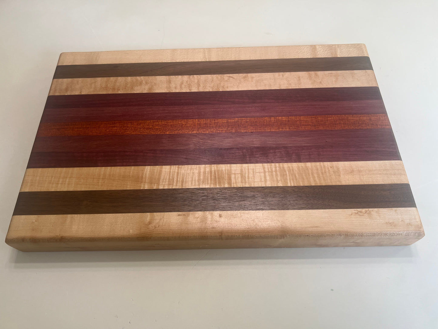 Hand made Hardwood Cutting board - Made from walnut, maple, Purple Heart, and blood wood.
